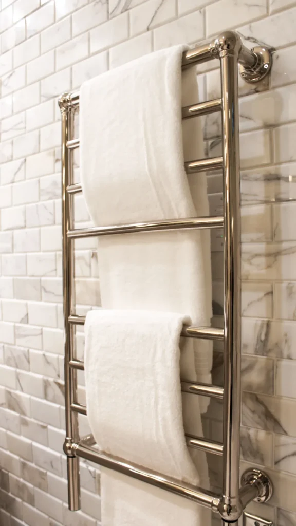 small bathroom ideas 2026 heated towel rail folded linen towels styled