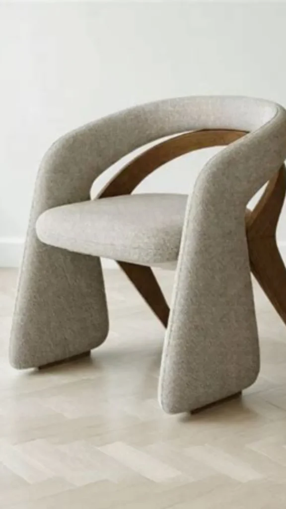 curved accent chair sculptural wood frame exposed upholstered cushions