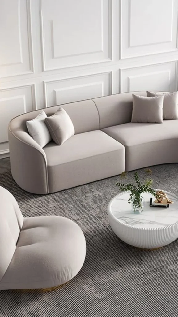 how to style curved sofa accent chair contrasting fabric pairing