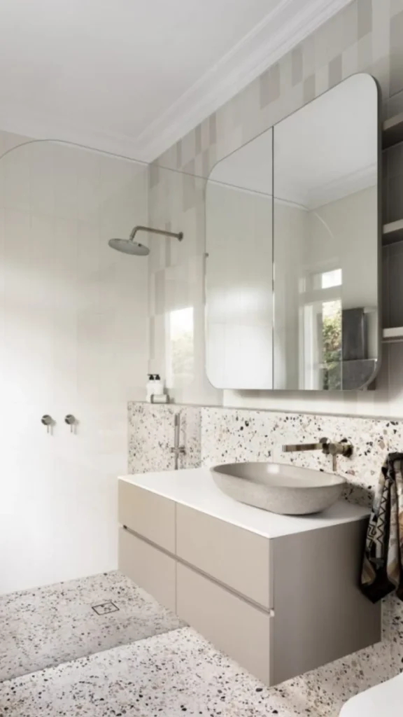 small bathroom ideas 2026 terrazzo flooring subtle personality warm neutral