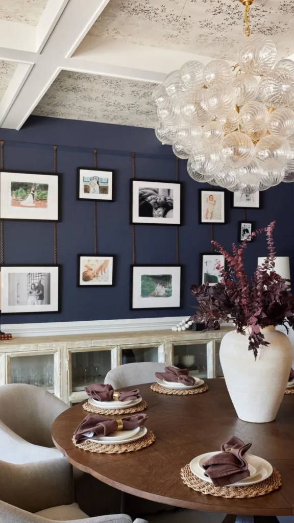 gallery wall dining room picture lights illuminated warm above frames