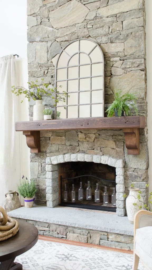 stone fireplace ideas arched mirror above mantel