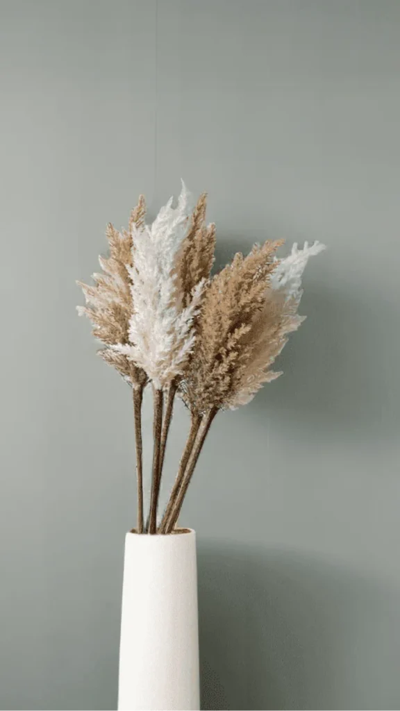 organic modern coffee table styling single tall ceramic vase dried pampas stem clear travertine 2026