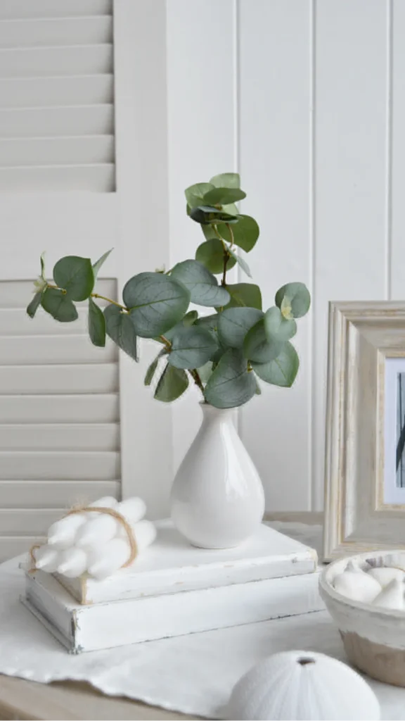 organic modern coffee table styling two books ceramic eucalyptus bud vase warm wood table 2026