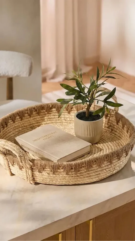 organic modern coffee table styling woven seagrass tray three natural objects generous empty space 2026