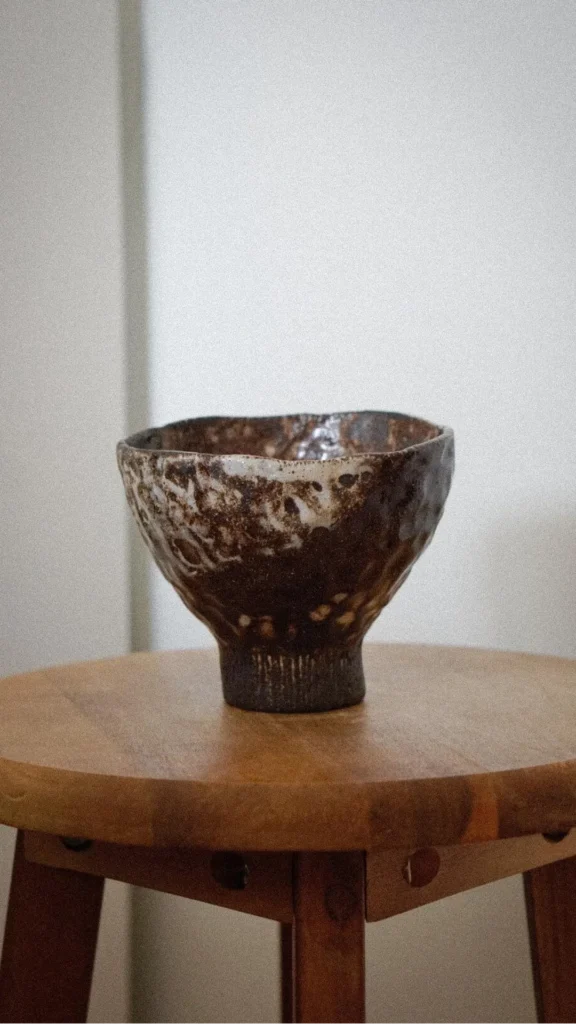 japandi console table styling wabi-sabi ceramic bowl river stone completely clear warm wood console 2026