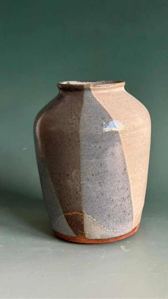 wabi-sabi objects organic modern home hand-thrown ceramic vase visible irregular rim warm wood 2026
