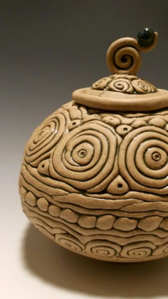 wabi-sabi objects organic modern home hand-coiled clay pot visible fingermarks coil texture warm surface 2026