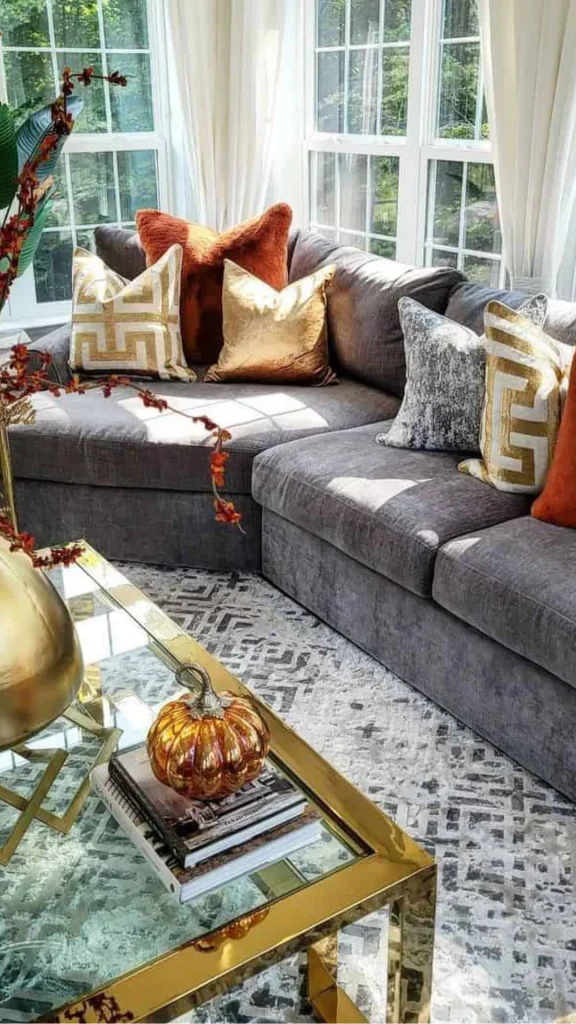 grey boho living room ideas layered rust terracotta mustard cushions grey sofa 2026